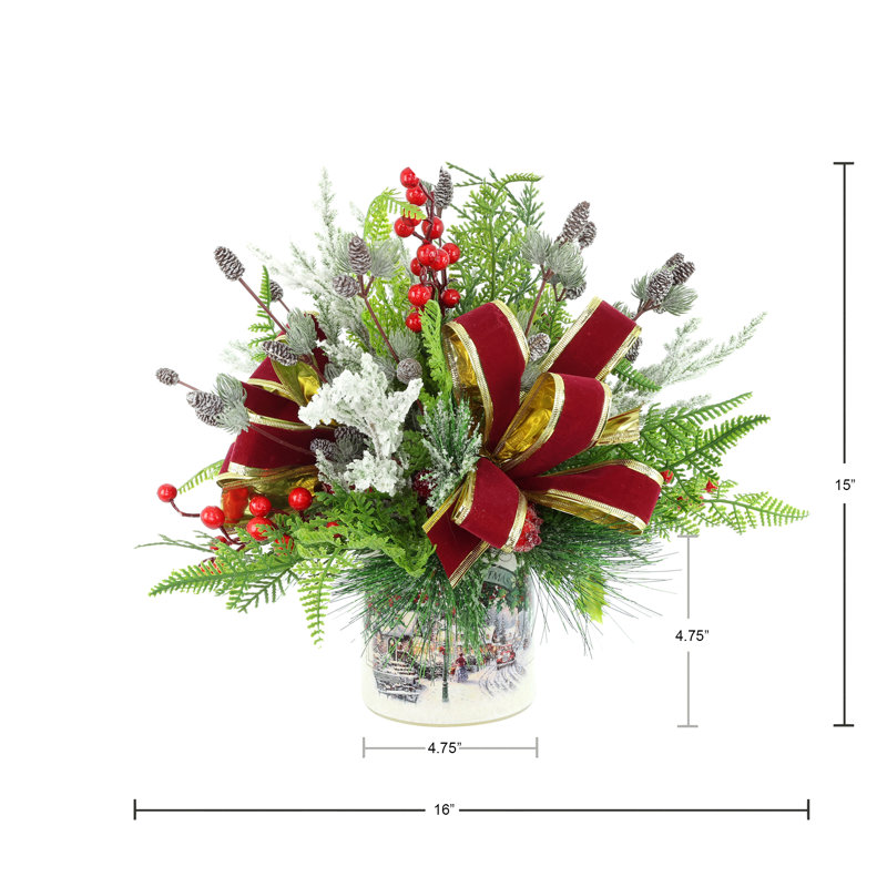 Festive holiday arrangement with greens and Berries