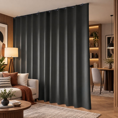 Extra-wide black blackout room-divider curtain with a flexible sliding curtain rod and ceiling curtain track set for wall-mounted room separation and privacy; Black Drape & Black Rail, W 108 x H 96 in.