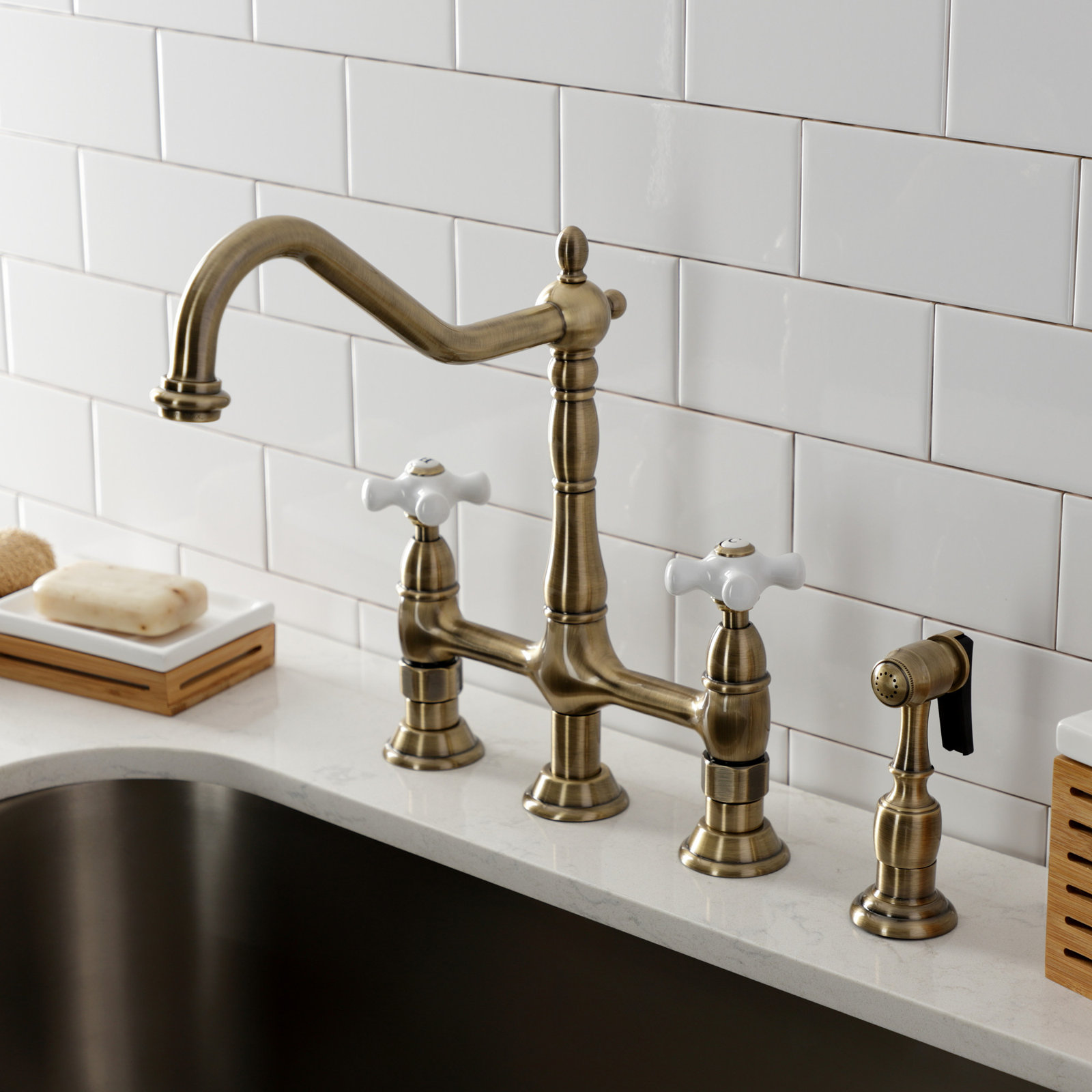 Kingston Brass Heritage Two-Handle 4-Hole Deck Mount Bridge Kitchen Faucet with Brass Side Sprayer, Vintage Brass