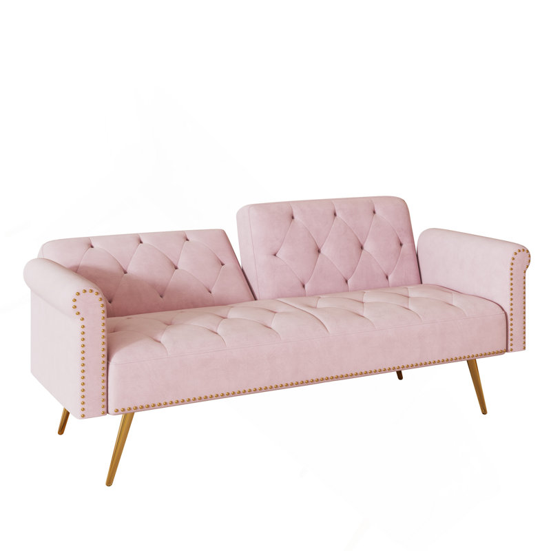 Un canapé-lit de 69,7 po de long recouvert de velours rose, doté d'une garniture cloutée et d'un coussin décoratif assorti