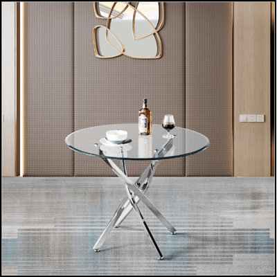 Table de salle à manger ronde contemporaine en verre trempé transparent avec pieds élégants en acier inoxydable à finition argentée, parfaite pour les intérieurs modernes et les espaces compacts.