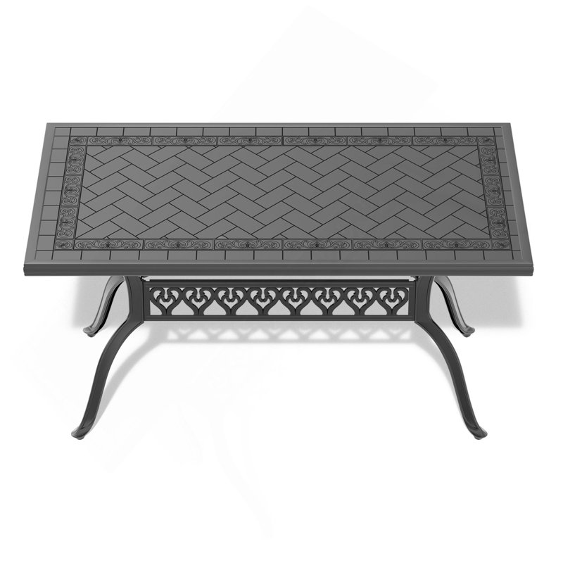Table de salle à manger en fonte d'aluminium avec cadre noir et texture sculptée sur le plateau de table