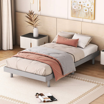 Lit flottant gris moderne pour une personne, cadre stable et élégant, grande durabilité.