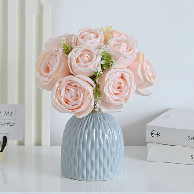 Arrangement floral de roses artificielles en plastique dans un pot