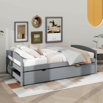 A Twin-Sized Platform Bed Accompanied By A Twin-Sized Underbed Trundle