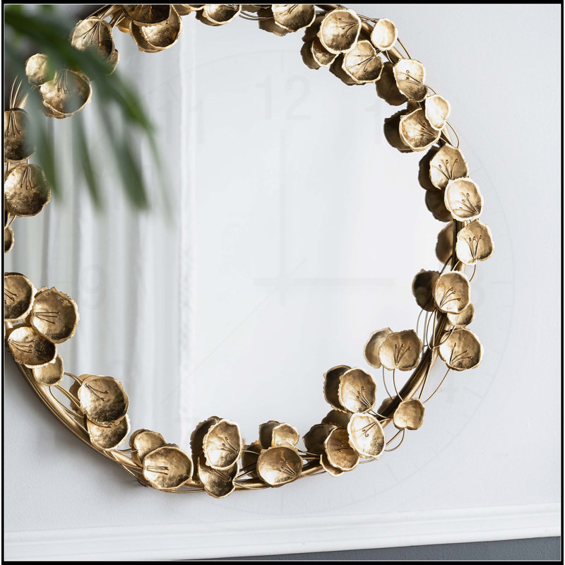 Exquis miroir mural rond en métal avec des accents de feuille d'or, idéal pour rehausser la décoration intérieure