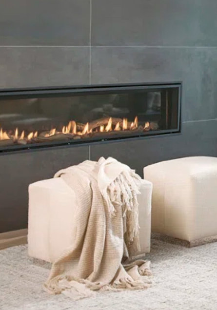White ottomans in front of fireplace
