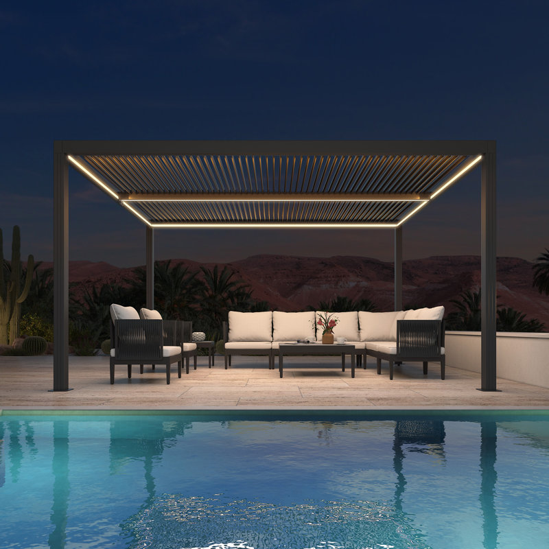 Modern gray aluminum louvered pergola with integrated LED strip lighting over a patio sectional sofa and coffee table next to a pool.