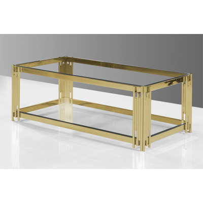 Table basse avec plateau en verre transparent et base en acier inoxydable poli doré