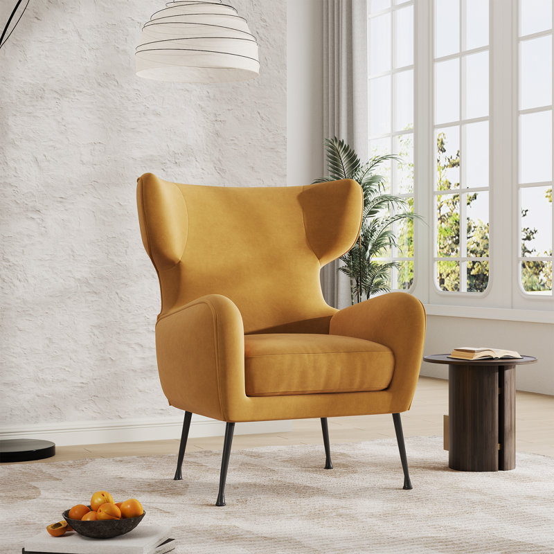 Fauteuil à oreilles rembourré en velours avec structure en bois massif