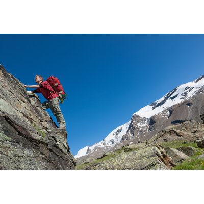 " Man Climbing Up Rock "