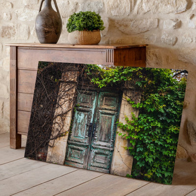 Canvas A Weathered Ornate Wooden Door Stands Prominently In The Center Wall Art Adorned With Intricate Carvings And A Faded Turquoise Canvas Wall Art