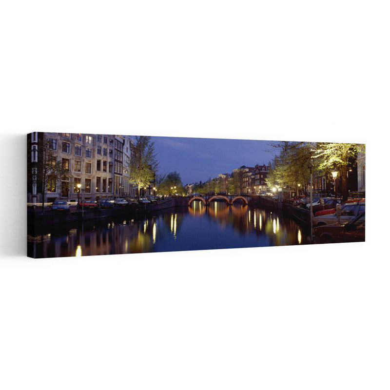 Night View Along Canal Amsterdam The Netherlands by Collezione Panoramica - Wrapped Canvas Panoramic Print
