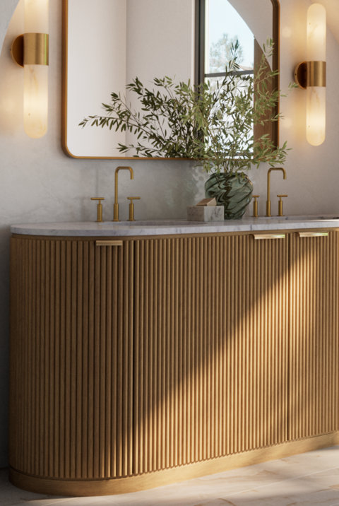 A bathroom vanity with fluted wood doors, marble countertop, and dual faucets.