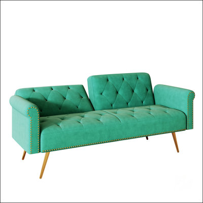 Luxueux canapé-lit en velours vert avec garniture cloutée et coussin décoratif assorti pour un confort élégant