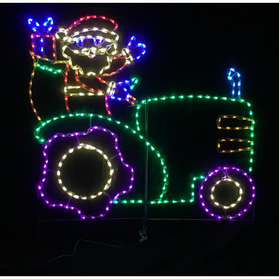 Père Noël au volant d'un tracteur lumineux