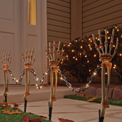  Halloween Warm White 18 in. LED Prelit Chained Skeleton Arms Pathway Decor