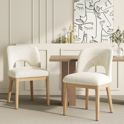 Élégante chaise de salle à manger rembourrée avec dossier creux incurvé et pieds en bois massif