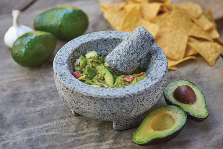 stone mortar and pestle set with guacamoles 