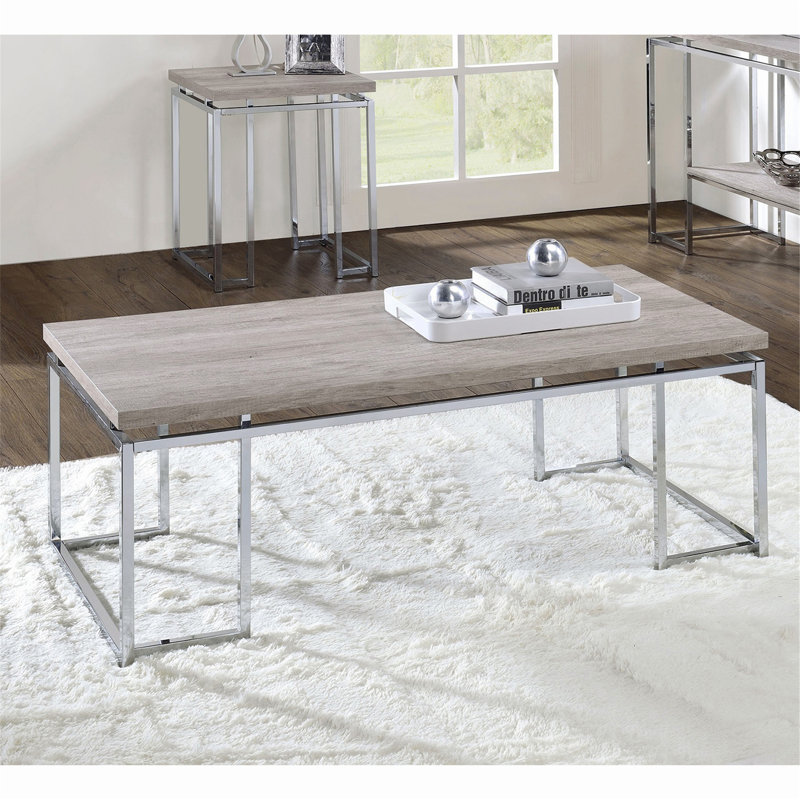 Table basse rectangulaire avec base luge en métal, avec un plateau en placage de chêne naturel et une finition chromée pour un look contemporain et sophistiqué