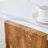 Harmonia 31" Pentagonal Coffee Table with Marble-Effect Top & Triangular Wood Base