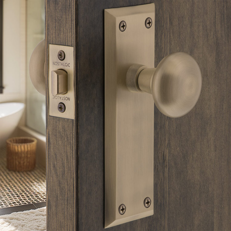 New York Plate with New York Door Knob, Antique Brass, 2-3/4”
