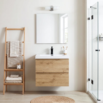 Meuble-lavabo suspendu de 23,62 po en mélamine en bois avec portes à fermeture amortie et lavabo intégré en résine, entièrement assemblé.