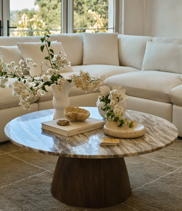 Round marble-top coffee table with book titled 'Rose Uniacke at Work'.