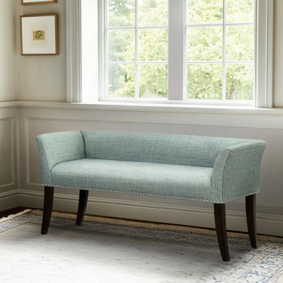 Banc d'appoint capitonné bleu sarcelle avec accoudoirs évasés, passepoil et siège en mousse haute densité offrant un soutien dorsal optimal. Tissu, idéal pour décorer un couloir. Construction robuste des accoudoirs. Un indispensable pour la chambre.