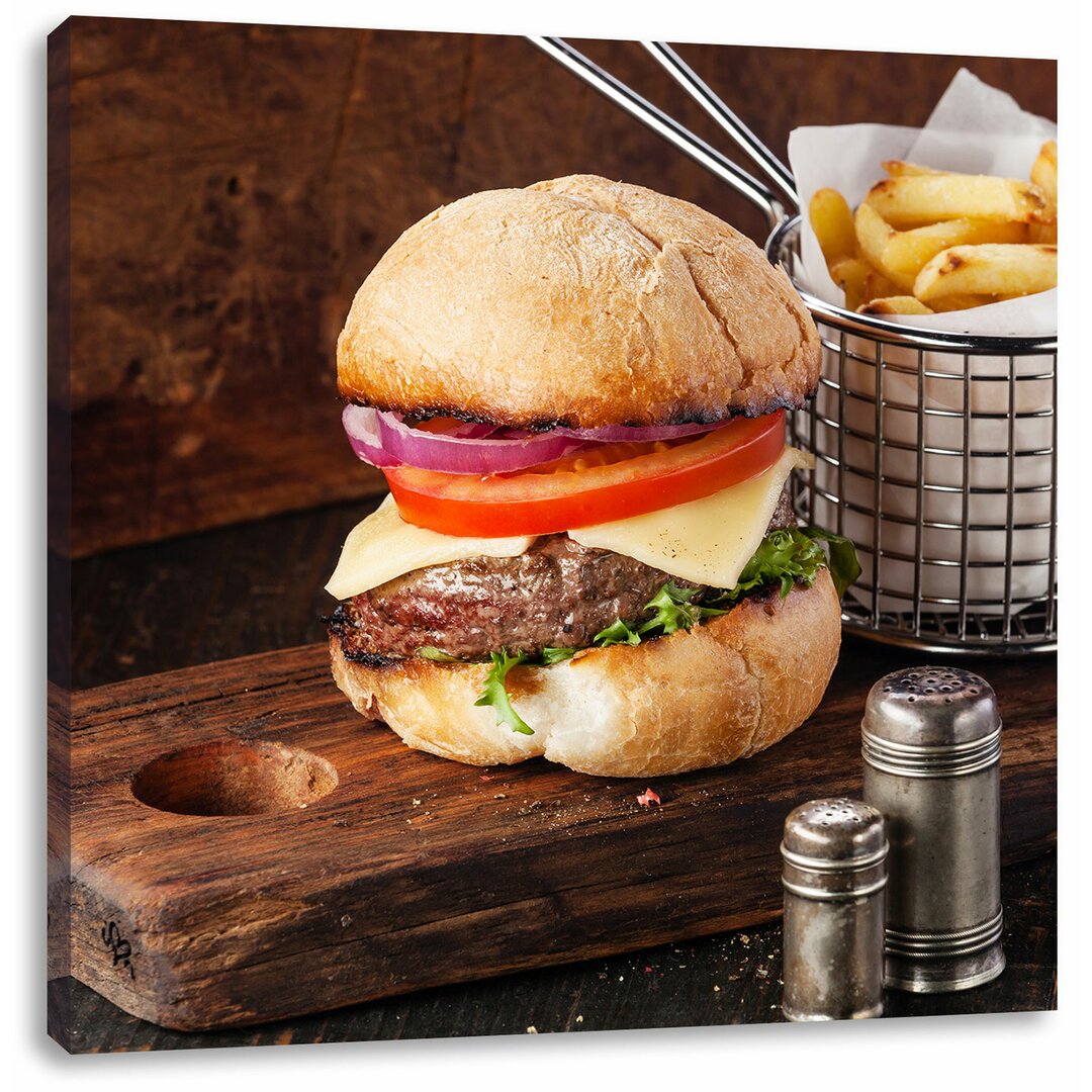 Leinwandbild Cheesburger mit Pommes