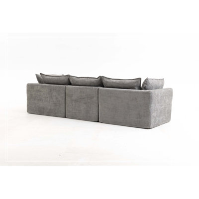Canapé d'angle modulaire surdimensionné Cloud Couch de 260 cm de large, offrant un confort optimal et une assise large et profonde. Revêtement en tissu gaufré, 3 places avec pouf.
