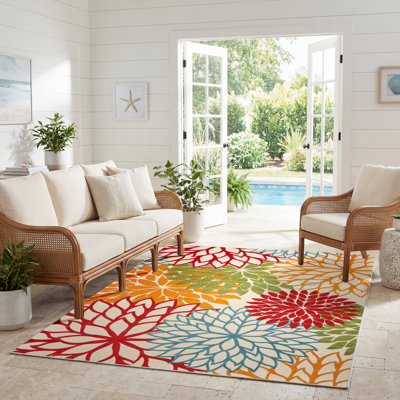 Tapis intérieur / extérieur vert / rouge / orange à motif floral Miraloma