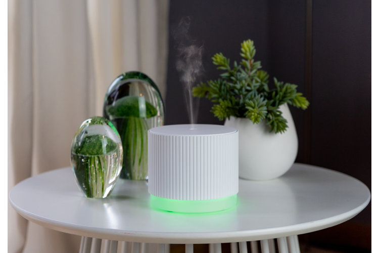 a small side table with a white aromatherapy diffuser