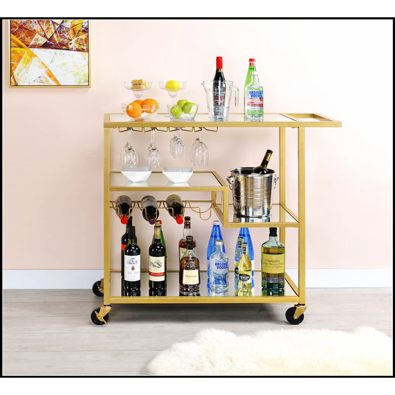 Chariot de service Adamsen avec miroir et finition champagne avec porte-bouteilles et porte-verres à pied, parfait pour les réceptions et un rangement élégant.