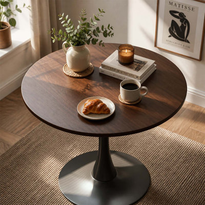 Table de salle à manger ronde moderne avec un piètement robuste à une seule colonne, idéale pour les petits espaces et une utilisation quotidienne polyvalente.