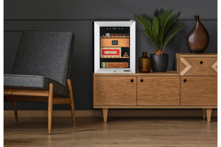 electric humidor on a wood console table next to a plant and vase
