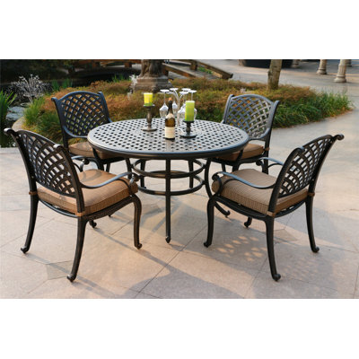 Annecorinne 4 - Person Patio Dining Set with Round Table , Cushions Included