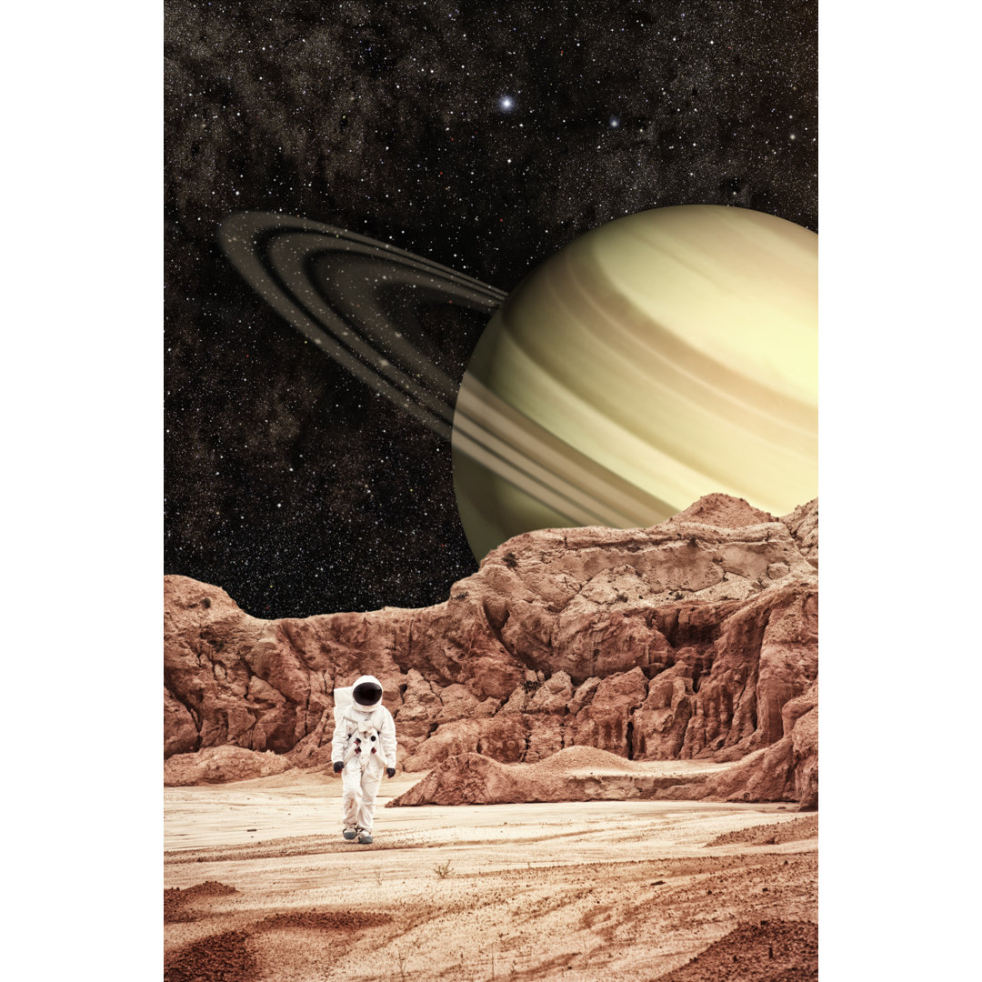 Astronaut Walking Saturn Moon von Inhauscreative - Leinwandbilder Kunstdrucke