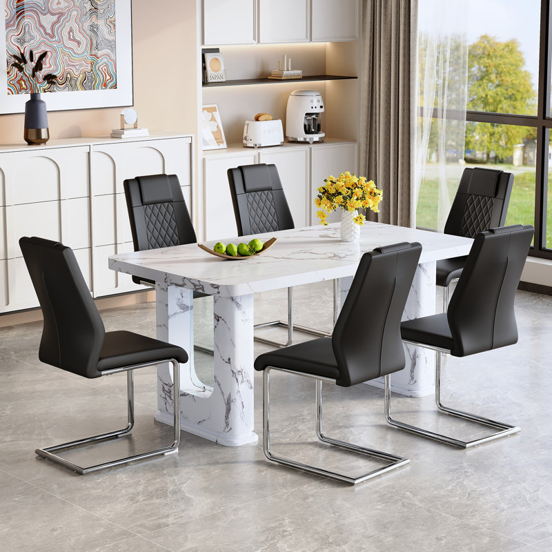Ensemble de table de salle à manger élégant en marbre blanc avec 6 chaises en polyuréthane noir, pieds en métal arqués argentés - Design moderne et élégant pour les salles à manger et les cuisines
