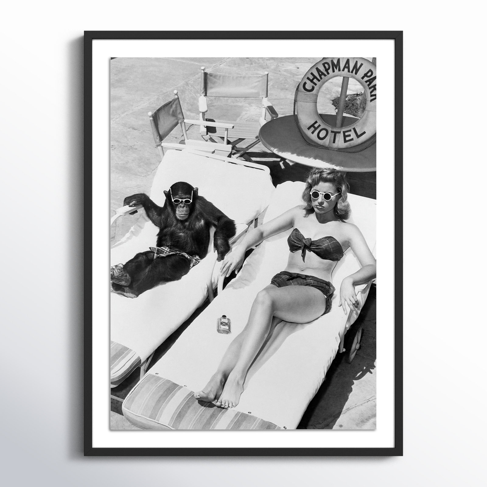 Woman Sunbathing With Chimpanzee by Getty Images, 32" H x 24" W, Black Maple Framed