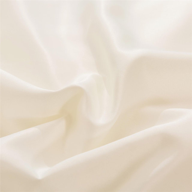 Close-up of ivory colored silk fabric.