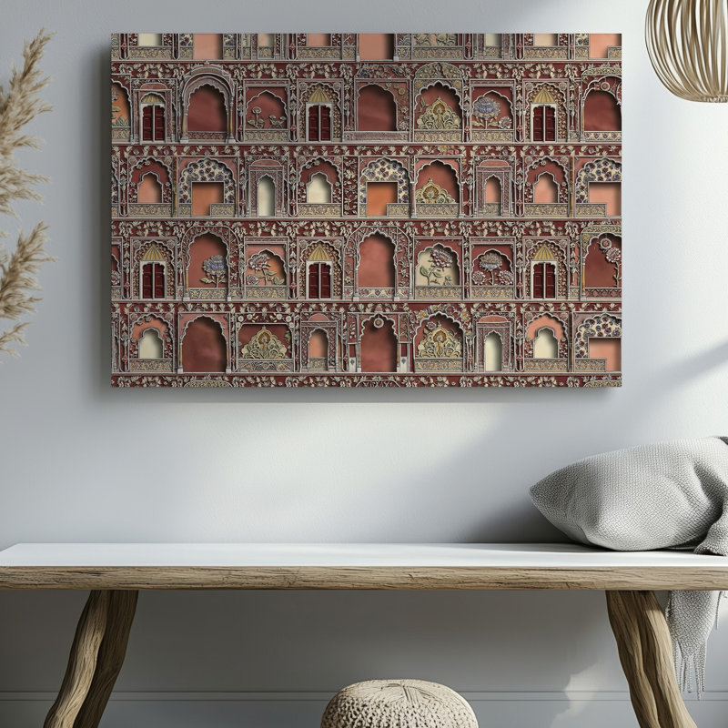La toile crée un design de tissu richement texturé mettant en vedette un collage d'art mural aux motifs architecturaux indiens complexes, y compris un art mural sur toile arquée