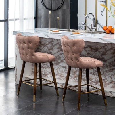 Pink Mid-Century Modern Counter Stools   Of 2  - Faux Leather , Nailhead Trim, Suede-Like Upholstery, Button Back, Tapered Walnut Legs, Gold Metal Footrest Style 2 Trimmed, Gold Footrest, Curved