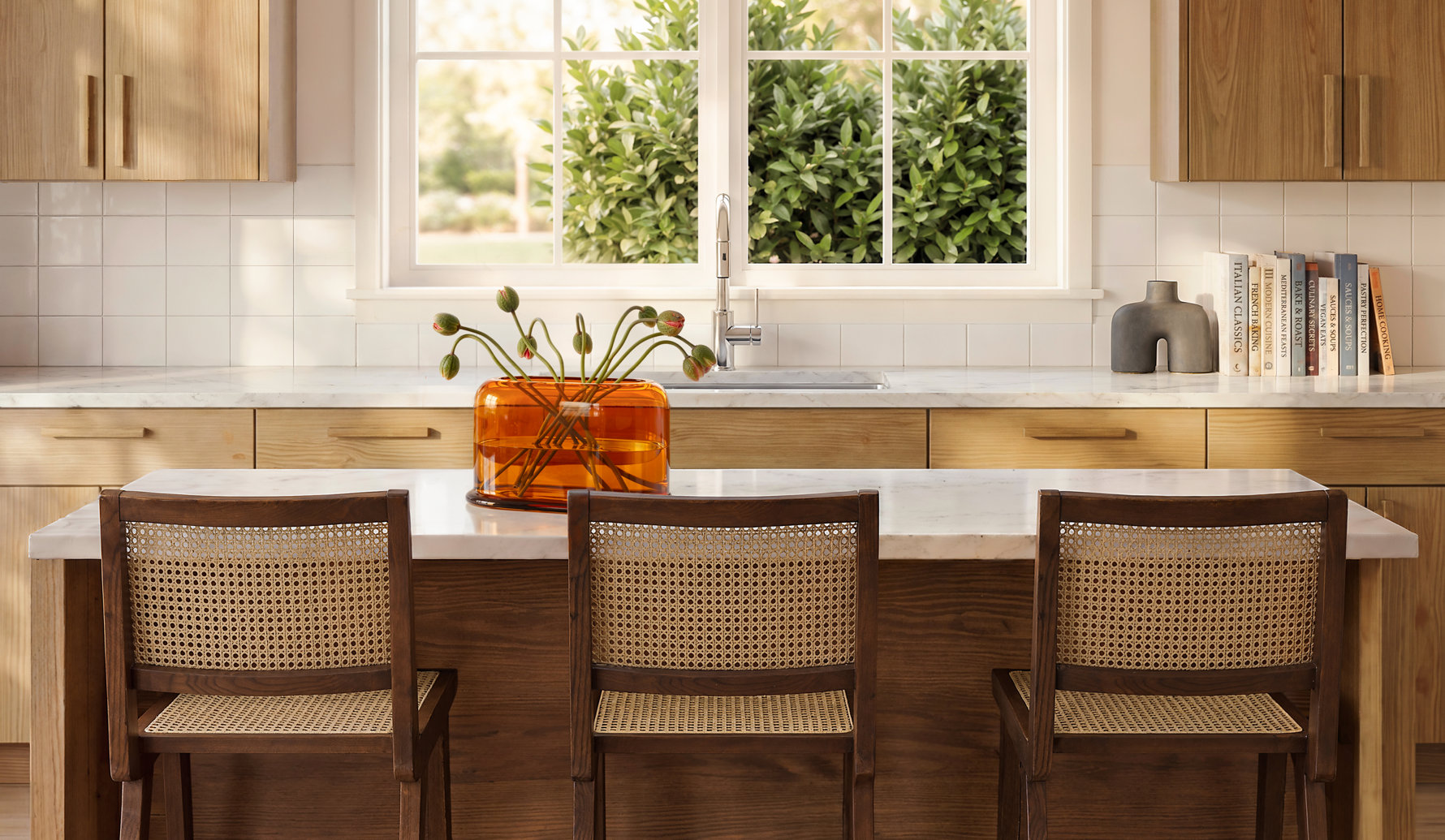 Modern kitchen island with three dark wood chairs featuring cane backs, situated in front of light wood cabinetry, a marble countertop, and a window with garden views.