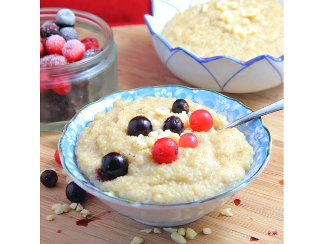 Bowl with breakfast quinoa porridge and berries on top.