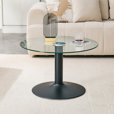 Table basse ronde en verre trempé de 27,5 pouces de diamètre. 17,7 pouces de haut, soutenu par une base en métal noir, avec un bord de luxe léger.
