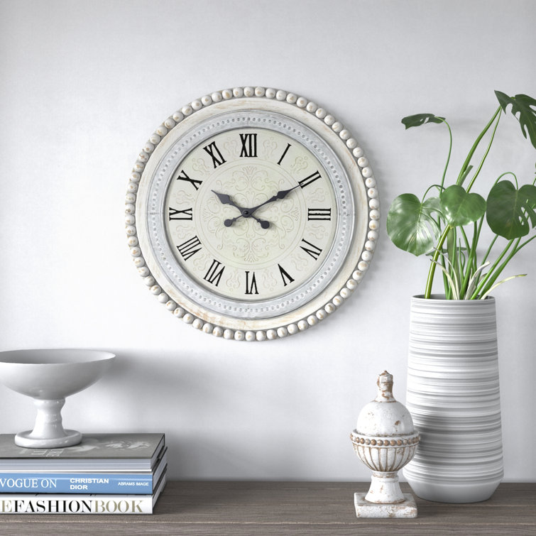 https://assets.wfcdn.com/im/60307834/resize-h755-w755%5Ecompr-r85/1947/194775138/Fontanel+White+Wood+Carved+Beading+Wall+Clock+22%22+x+1%22+x+22%22.jpg