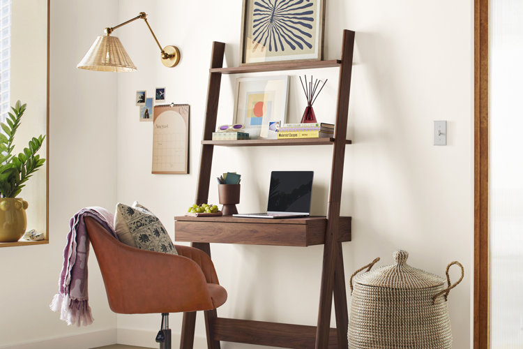 leaning ladder desk with a burnt orange velvet rolling chair