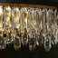 Lustre linéaire à 10 lumières de 119 cm (47 po) de largeur, à intensité variable, en cristal noir et laiton, idéal pour îlot de cuisine.