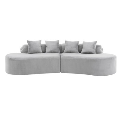 Modern And Simple Curved Flannelette Sofa. Creative Multi-Seater In Light Gray For The Living Room, With A Combination Of Pillows.
